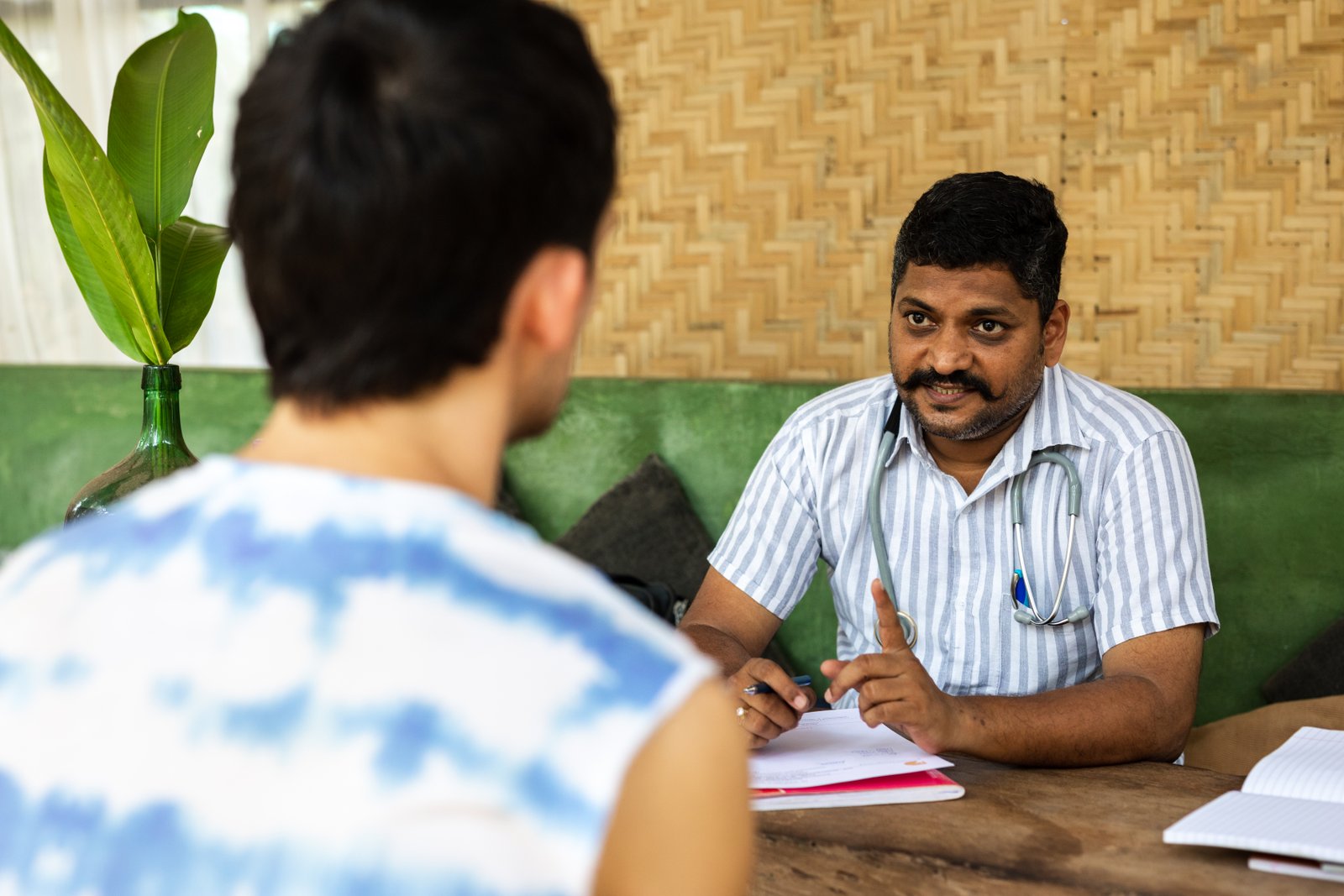 An Ayurvedic physician in consultation with a guest at SWAN Ayurveda, Goa