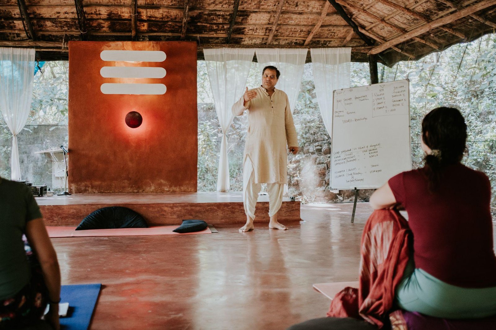A teacher addressing students in the SWAN shala