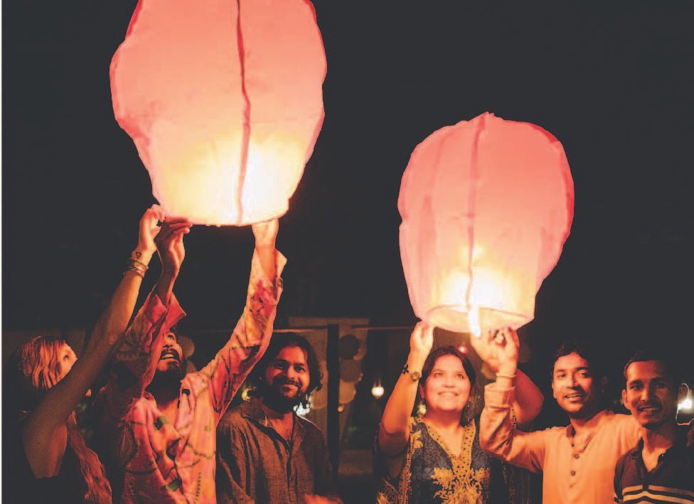 Guests releasing sky lanterns during an evening celebration at SWAN